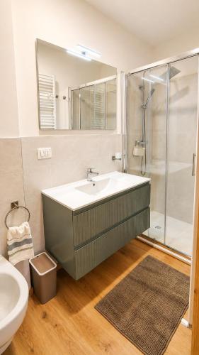 a bathroom with a sink and a shower at Verde Betulla, Free Park and Ski room in Camporosso in Valcanale