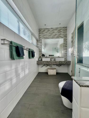 a bathroom with a tub and a sink and a mirror at Baan Tai Tara 4, Private Pool Villa by Ban Tai Beach in Ban Tai