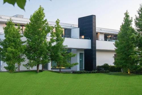 a house with a green lawn in front of it at Villa Bilor Luxe by MMega in Subbiano