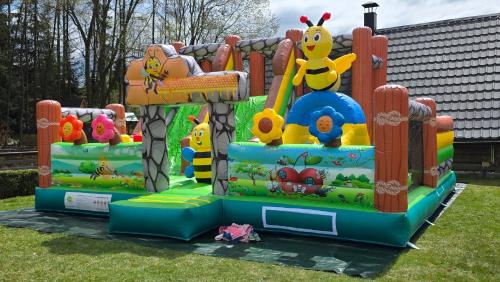 an inflatable playground with a play set in the grass at Willa Pod Kozińcem in Czarna Góra