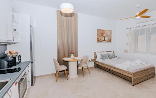 a bedroom with a bed and a table in a kitchen at Liopetro in Sitia