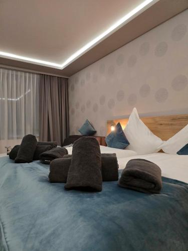 a hotel room with a large bed with pillows on it at TeMax Lux Hahnenklee in Goslar