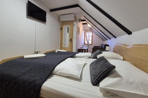 a bedroom with two large beds in a room at Sobe na vinskoj cesti Zmajevac in Zmajevac