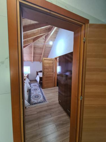 an open door into a room with a bedroom at Guest House Korabi in Ceren