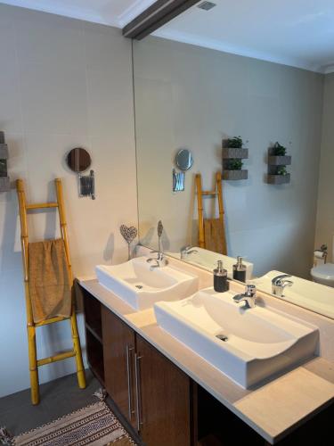 a bathroom with two sinks and a large mirror at Mountain and Sea in Ribeira Grande