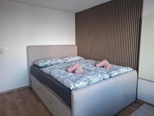 a bed with pink slippers on it in a room at Julia's Oase in Sasbachwalden