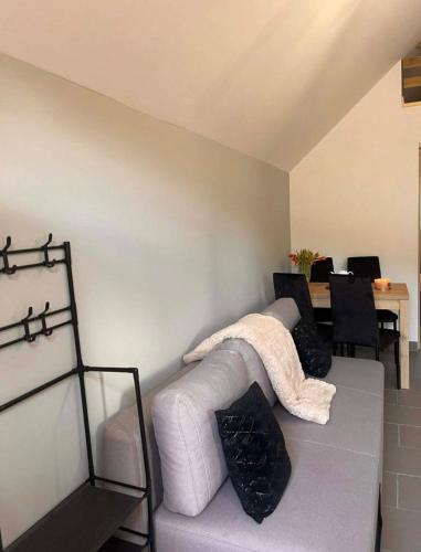 a living room with a couch with a blanket on it at Apartament Bydlino in Bydlino