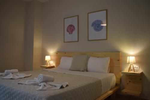 a bedroom with two towels on a bed with two lamps at Red Rose Garden in Tsilivi