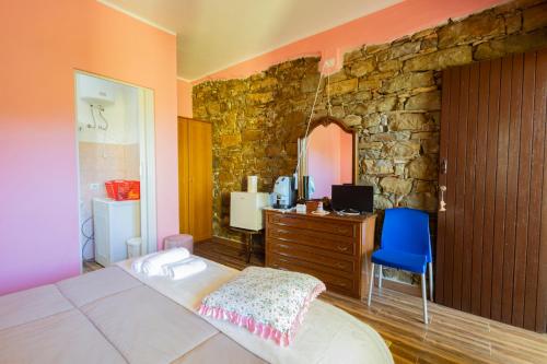 a bedroom with a bed and a stone wall at Casa Vacanza Capozzoli in Albanella