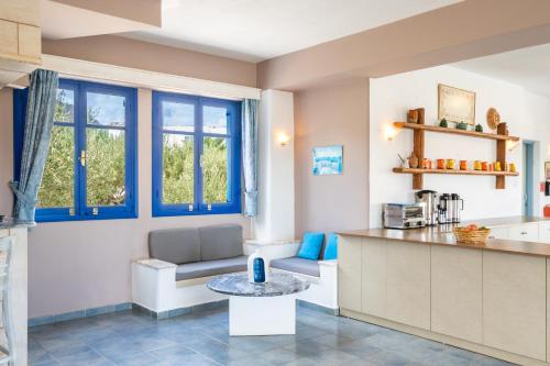 a kitchen with a counter and a table in a room at Blue Sea Hotel in Amoopi