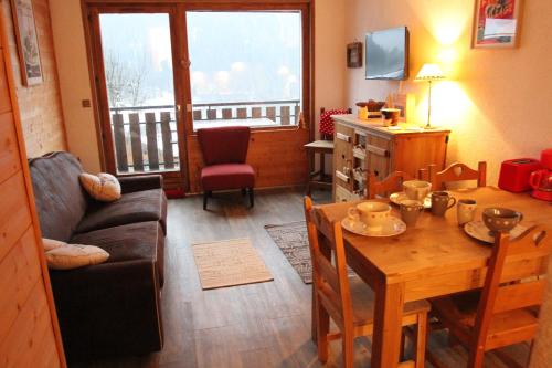 ein Wohnzimmer mit einem Tisch und einem Esszimmer in der Unterkunft Appartement Chatel Centre in Châtel