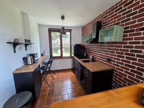 a kitchen with a brick wall and a counter at Still Garden House in Bezden