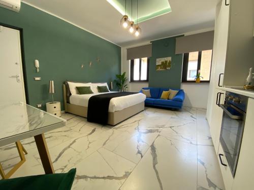 a bedroom with a king sized bed and a blue couch at Leo&Franci Loft in Legnano