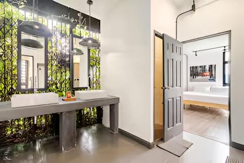 a bathroom with two sinks and a large mirror at Ombra House No. 21-24 in Chiang Mai
