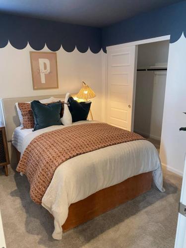 a bedroom with a large bed with blue walls at Todd's Relaxation Place in Maricopa