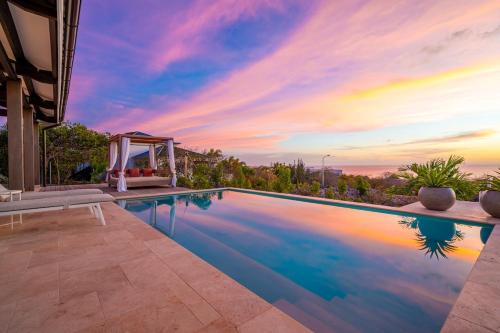 an infinity pool with a gazebo in a house at Luxe Villa met Panoramisch Zeezicht op Bonaire - Kas Ubuntu in Kralendijk