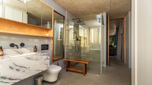 a bathroom with a shower and a toilet and a sink at Mi Amor Beach House in Sedgefield