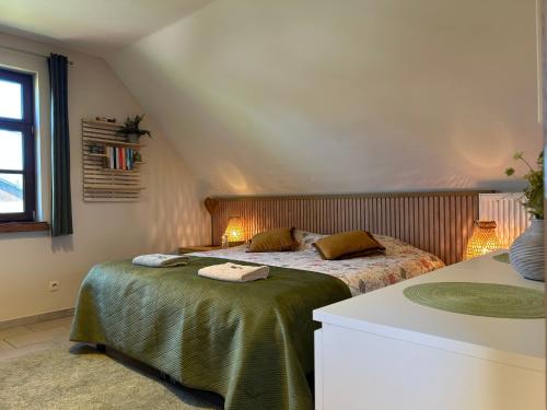 a bedroom with two beds in a attic at Au Coeur des Collines, Gloriette in Ellezelles