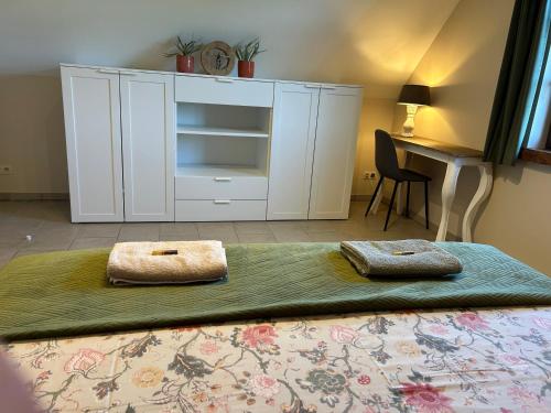 a bedroom with a bed with a white cabinet at Au Coeur des Collines, Gloriette in Ellezelles