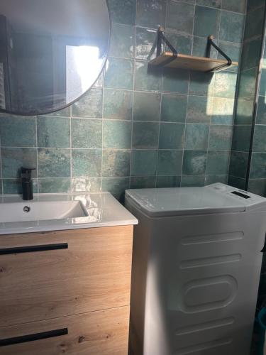 a bathroom with a sink and a toilet and a mirror at Umalas studio in Orange