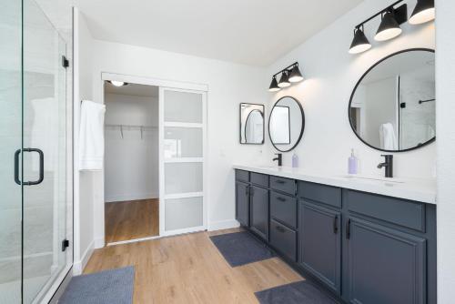 a bathroom with a sink and a mirror at NEWGamesTVsHeated PoolFirepitFireplace in Coachella