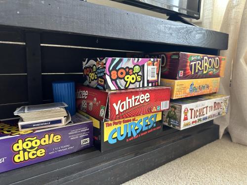 a shelf filled with boxes of cereal and books at Charming, Spacious, Contemporary Mountain Retreat in Whitehall