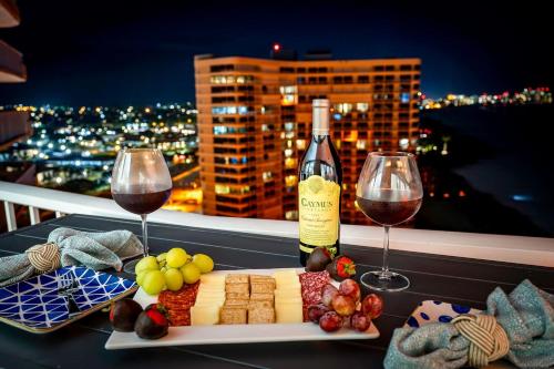 a plate of cheese and wine on a table with wine glasses at Waterfront Condo Beach Access & Pool Luxury in Marco Island