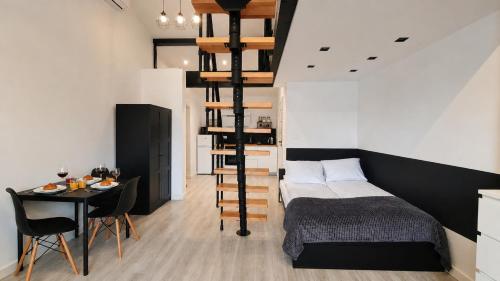 a bedroom with a bed and a table with a dining room at Dream Apartments 3B KLIMATYZACJA in Oświęcim