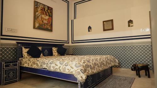 a bedroom with a bed with a blue and white bedspread at C 44 the local history in Jaipur