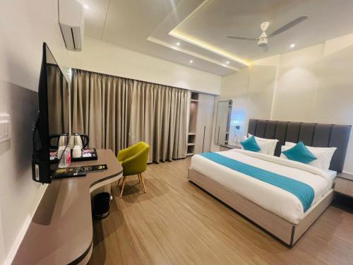 a bedroom with a bed and a desk in a room at Hotel Vedic Roots in Varanasi