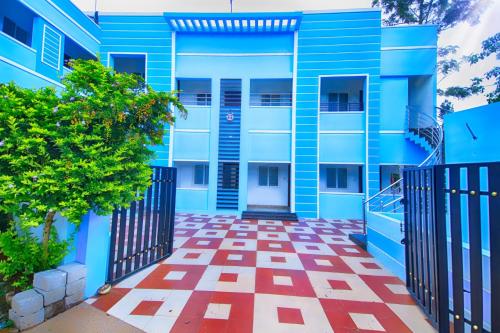 a blue building with a red and white checkered floor at Bluebell Holiday Inn in Yercaud