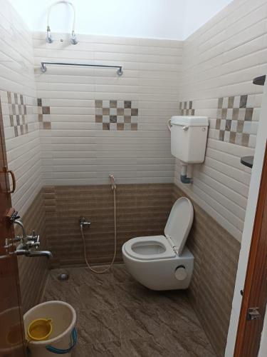 a bathroom with a toilet and a shower and a sink at Bluebell Holiday Inn in Yercaud