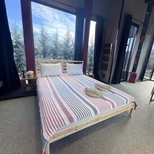 a large bed in a room with a large window at Baraka Suite in İznik