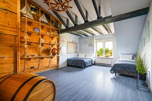 a bedroom with two beds and a wooden wall at Spa & Grill Family Villa - No Parties Allowed in Warsaw