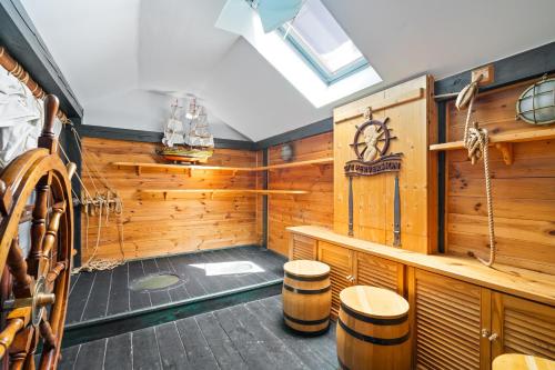 a sauna with wooden walls and wooden stools at Spa & Grill Family Villa - No Parties Allowed in Warsaw