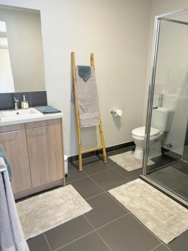 a bathroom with a shower and a sink and a toilet at Cozy room with an Ensuite in Clyde North