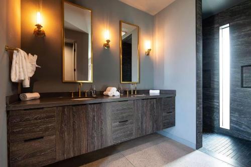 a bathroom with a sink and a mirror at Black C House Modern w pool spa in Yucca Valley