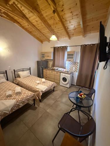 a small room with two beds and a table in it at Mani Sea View Rooms in Gythio