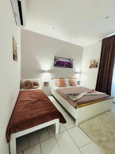 a bedroom with two beds and a window at Laura Rooms in La Spezia