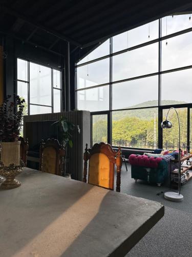 a large room with a table and large windows at Villa Baraka in İznik