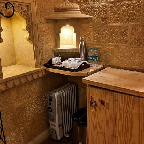 a kitchen with a counter with a microwave and a sink at Golden Celestial haveli jaisalmer in Jaisalmer