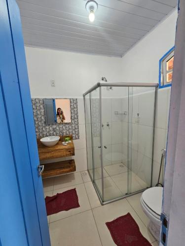 a bathroom with a glass shower and a toilet at San Sebastian Taipu de Fora in Marau