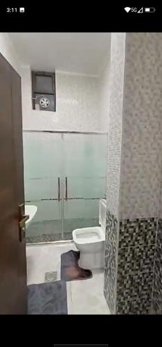 a bathroom with a toilet and a sink at فيلا سالم الاشقر in Amman