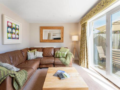 a living room with a couch and a table at Smugglers Den in Beadnell