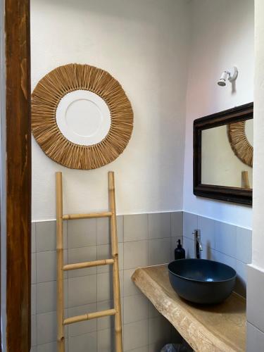 a bathroom with a sink and a mirror at azul rooms & suites in Olbia