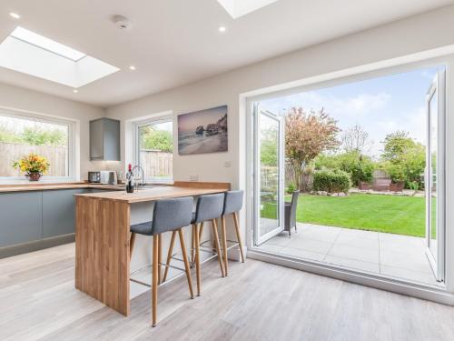 an open kitchen with a large sliding glass door at Whit's End House in Whitstable