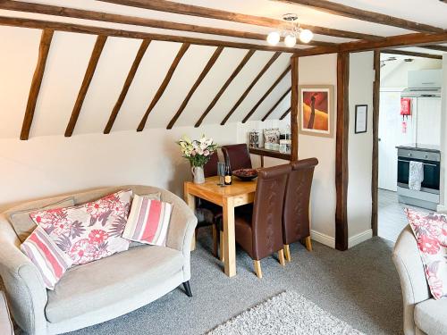 a living room with a table and two chairs at Hayloft-E2699 in Winthorpe