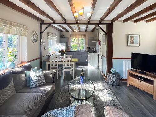a living room with a couch and a table at Archways-E1223 in Addlethorpe