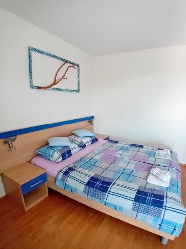 a bedroom with a bed and a table at Apartments Bambi in Lun