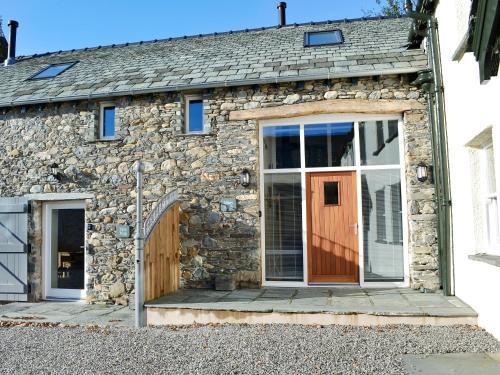 a stone cottage with a door and a window at Mary Rook Cottage - Uk1369 in Keswick